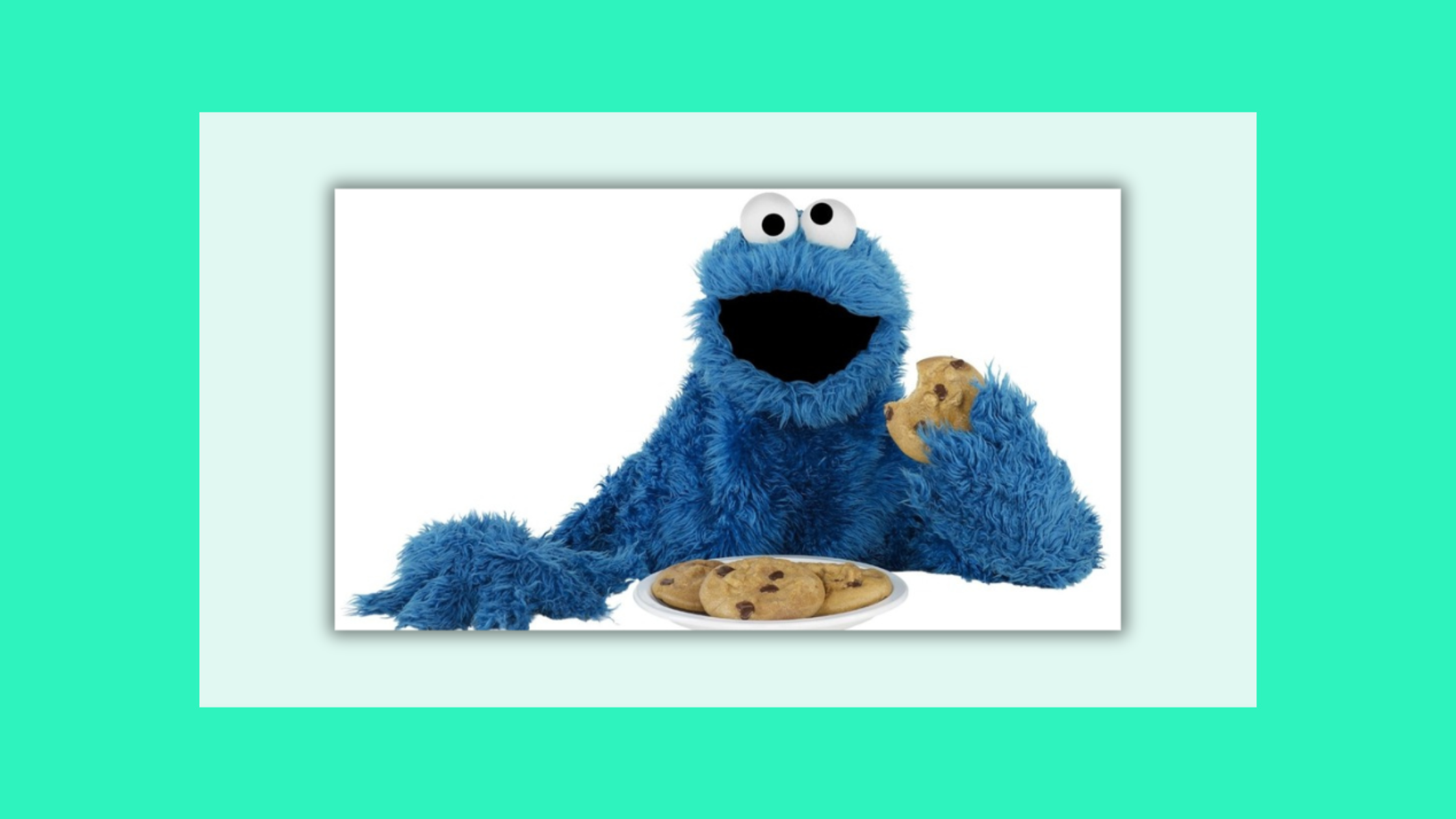 image of the blue cookie monster with a plate of cookies & 1 cookie in his hand